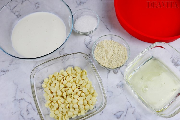 zutaten und produkte für osterkuchen mit weißer schokolade sahne mandelmehl und eiweiß