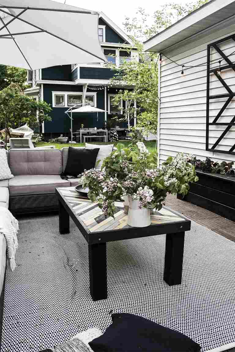 Terrasse skandinavisch gestalten in Schwarz und Grau und mit blühenden Pflanzen