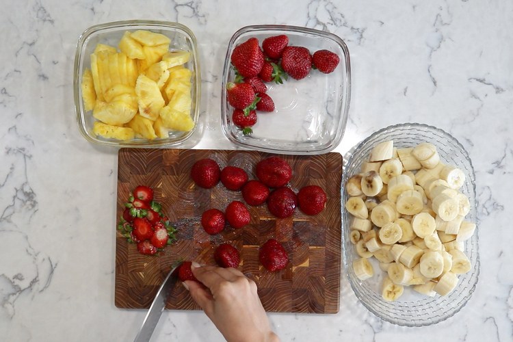 zutaten für nicecream aus bananen erdbeeren und ananas in stücken schneiden