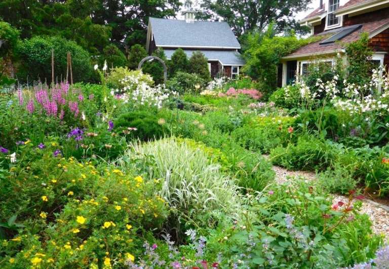 Großer Garten im englischen Cottage-Design mit üppigen Beeten