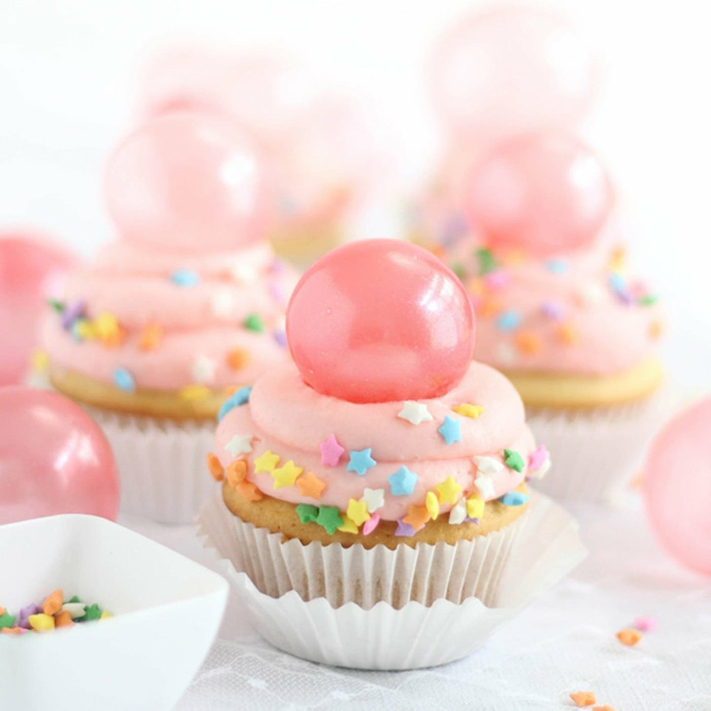 Romantic cupcakes with pink topping, starfish streusel and pink gelatin balls