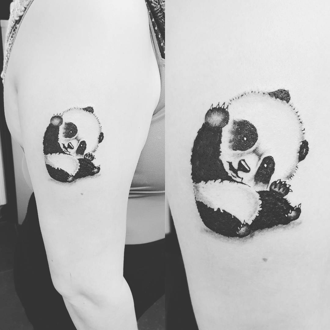 Black-and-white tattoo with thumb baby panda
