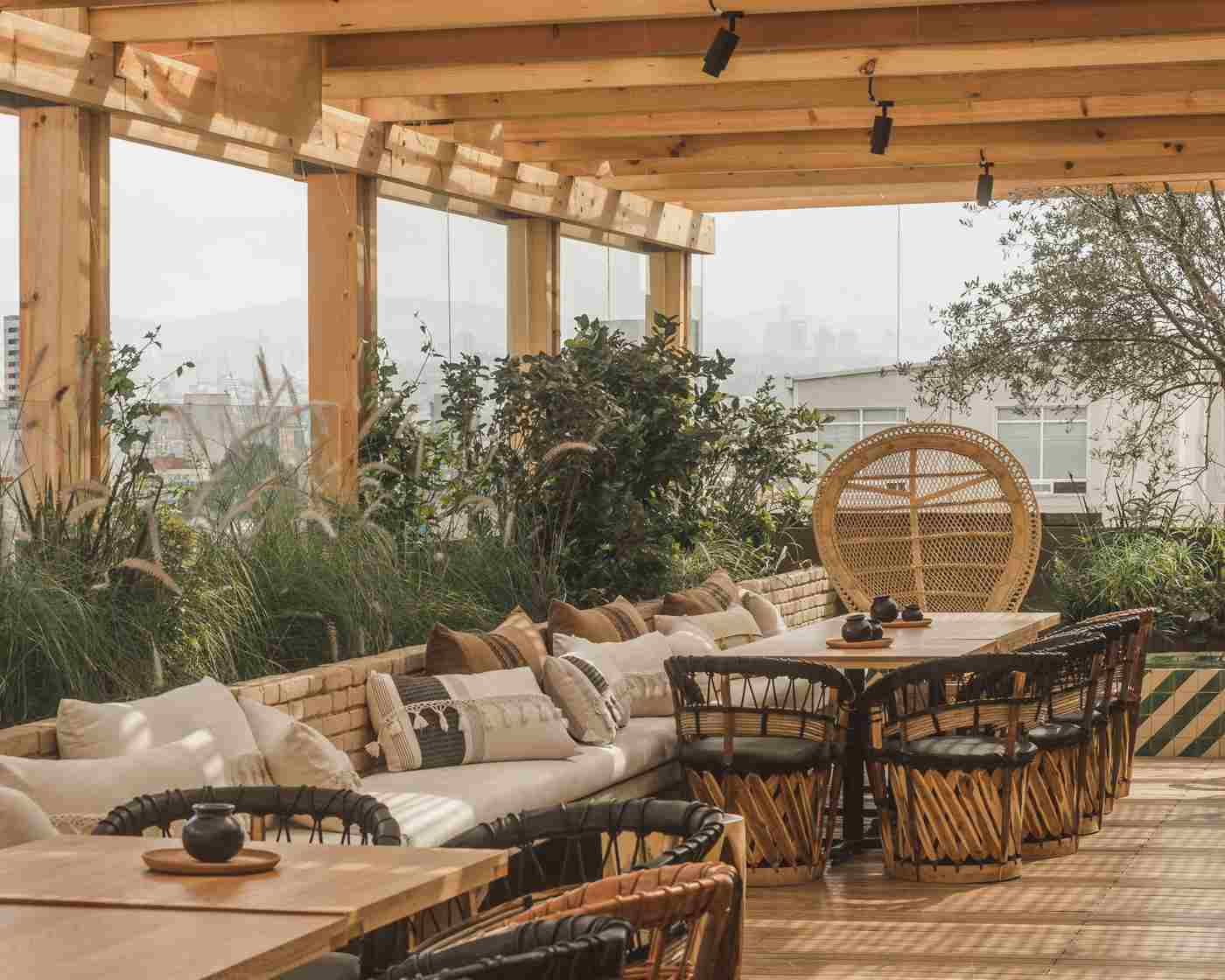 Bar stools and wooden roof terrace Pergola ornamental grasses