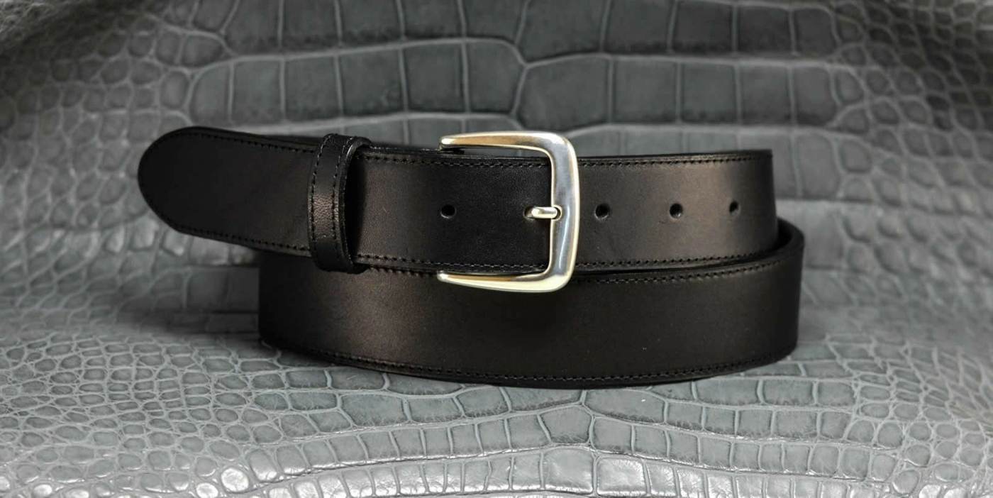 Black leather belt with metal cutter as a luxurious accessory