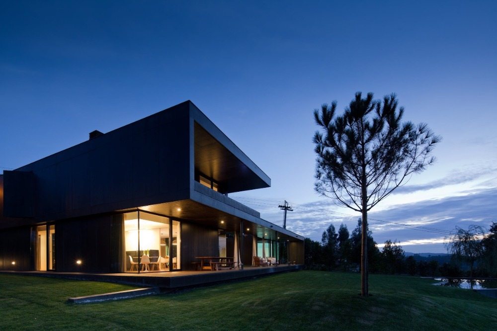 designer house made of black and dark building materials at sunset
