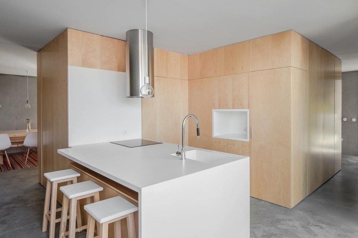 designer kitchen with white kitchen island in combination of wood and concrete