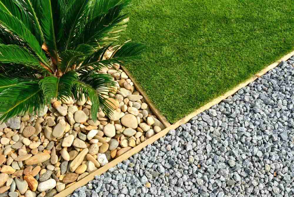 garden surround with charcoal pebbles and grass