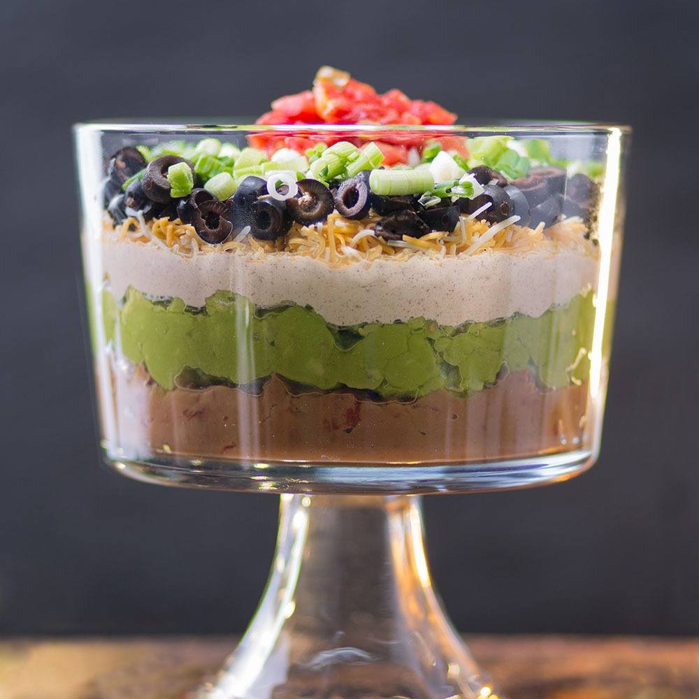 glass bowl with layers of Mexican layer salad