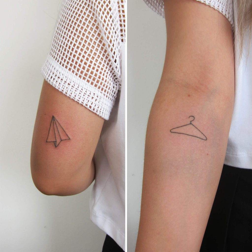 small paper flyer tattoo upper arm woman