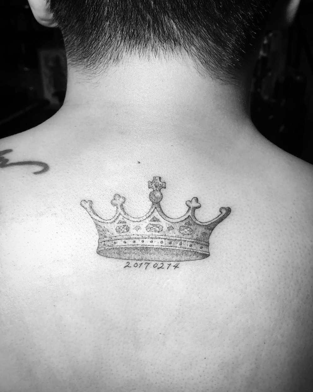 crown tattoo in back in gray with number