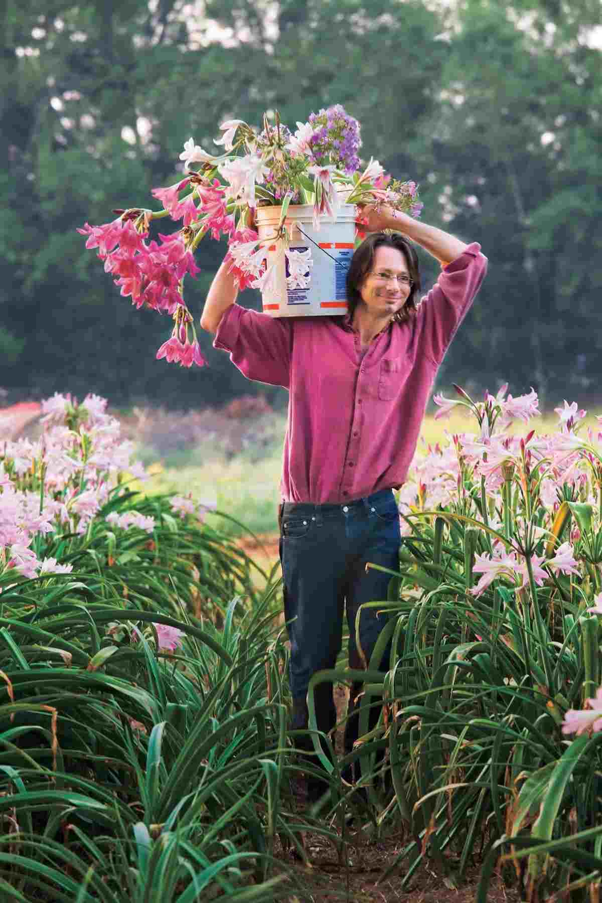 man likes to plant a bucket full of flowers to plant