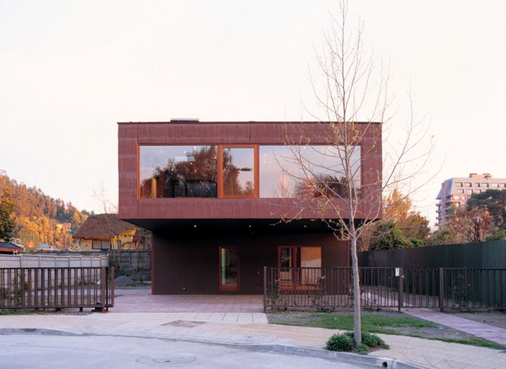 modern two-storey house built with rotating facade of visible concrete with courtyard