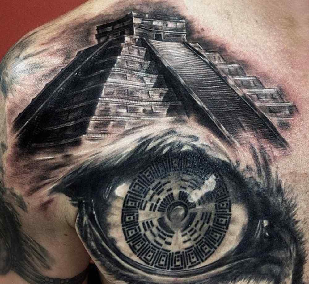 shoulder tattoo men with temple and eye as a broken tattoo