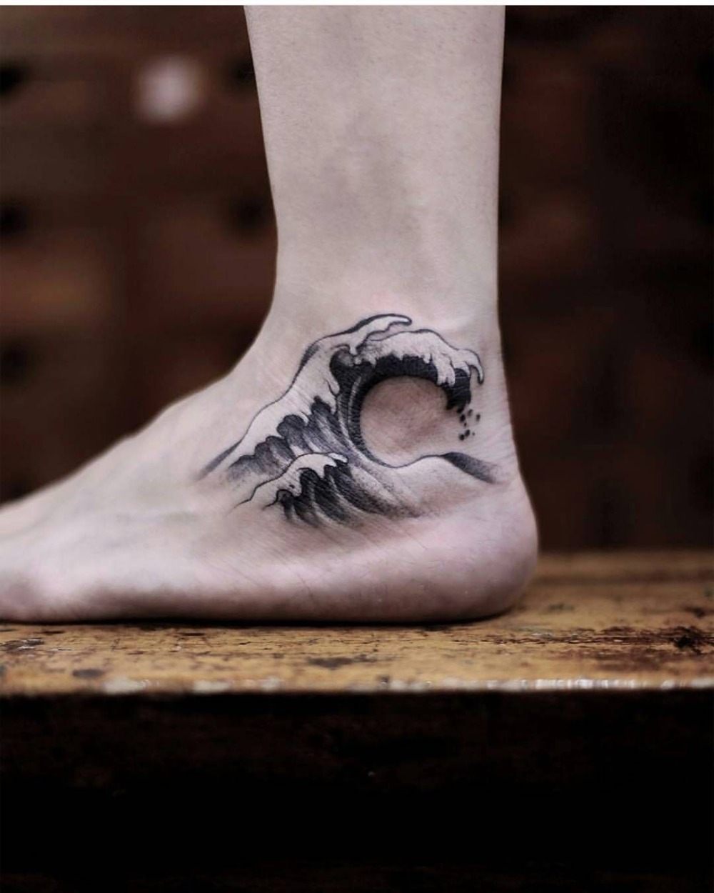 wave tattoo design in the foot tattoo for men