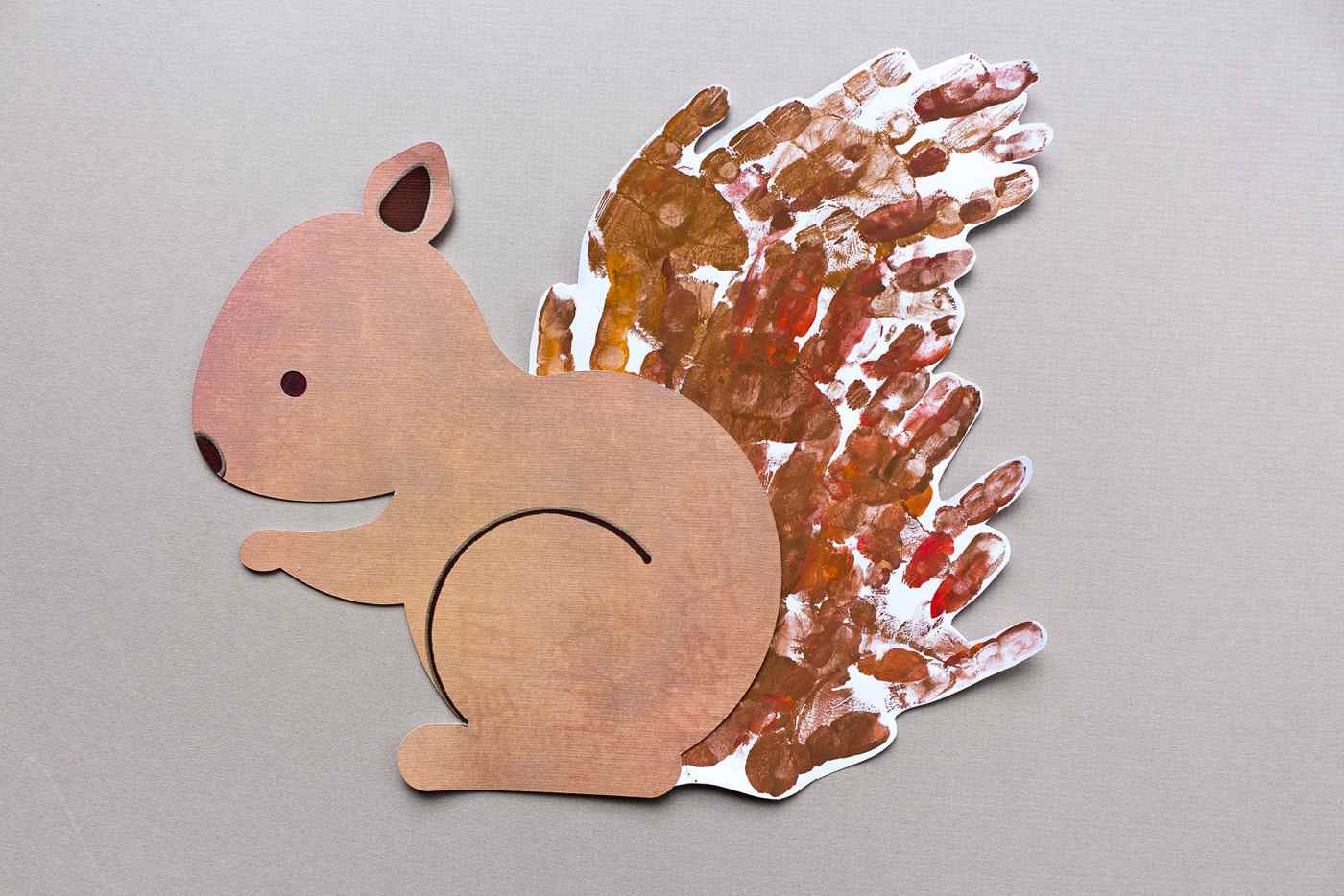 Cut out animal figures from paper and tail from fingerprints 