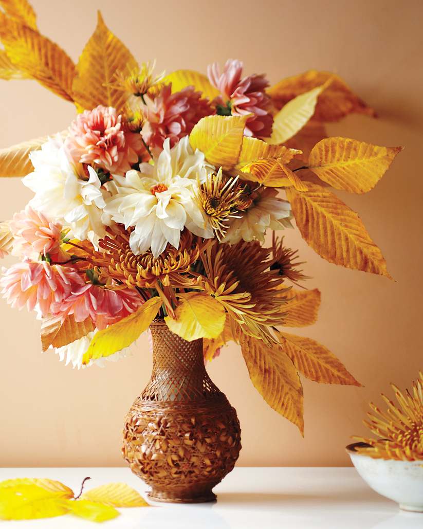 Autumn table cloth in gold autumn leaves and white dahlias and chrysanthemums combine
