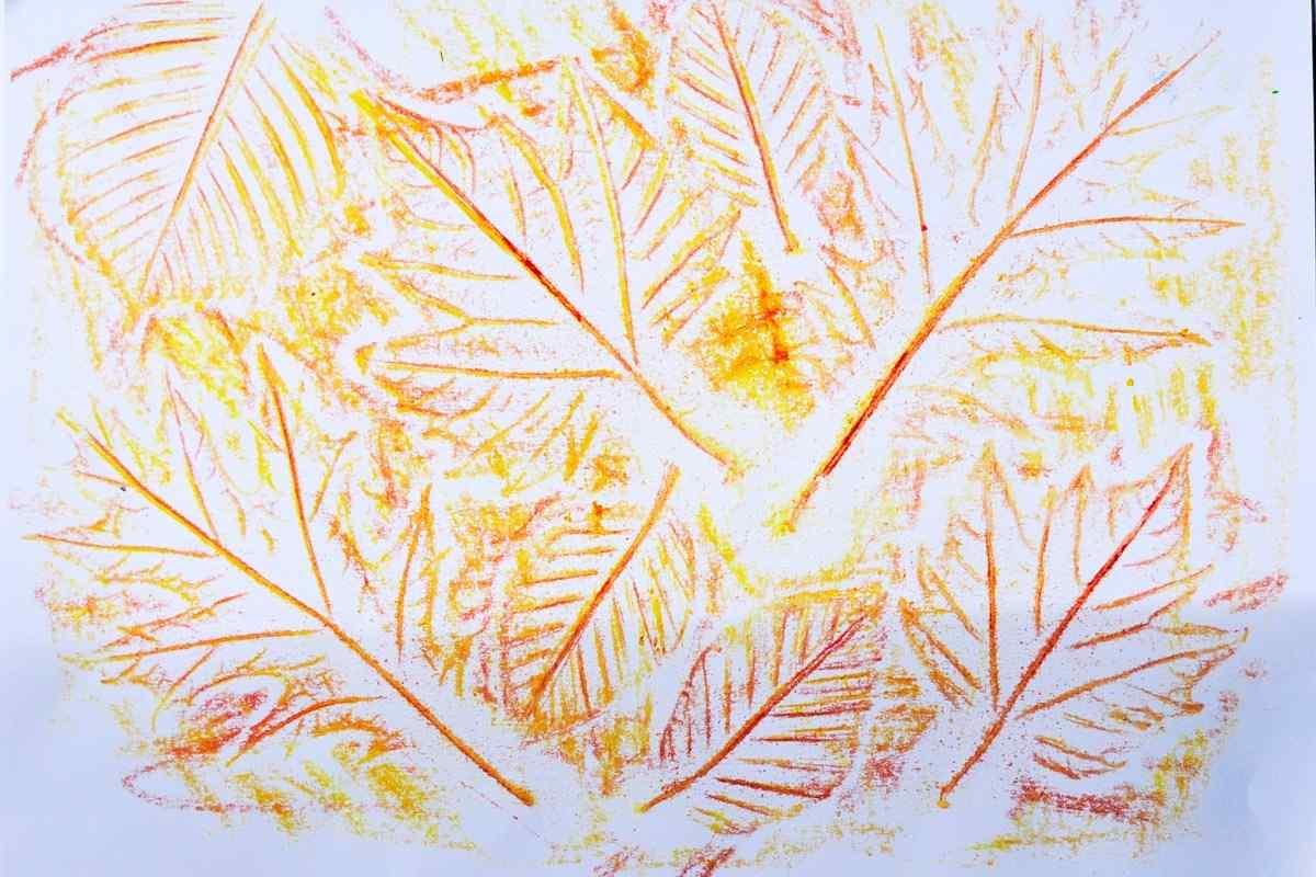 Paint beautiful autumn pictures with wax crayons and real leaves