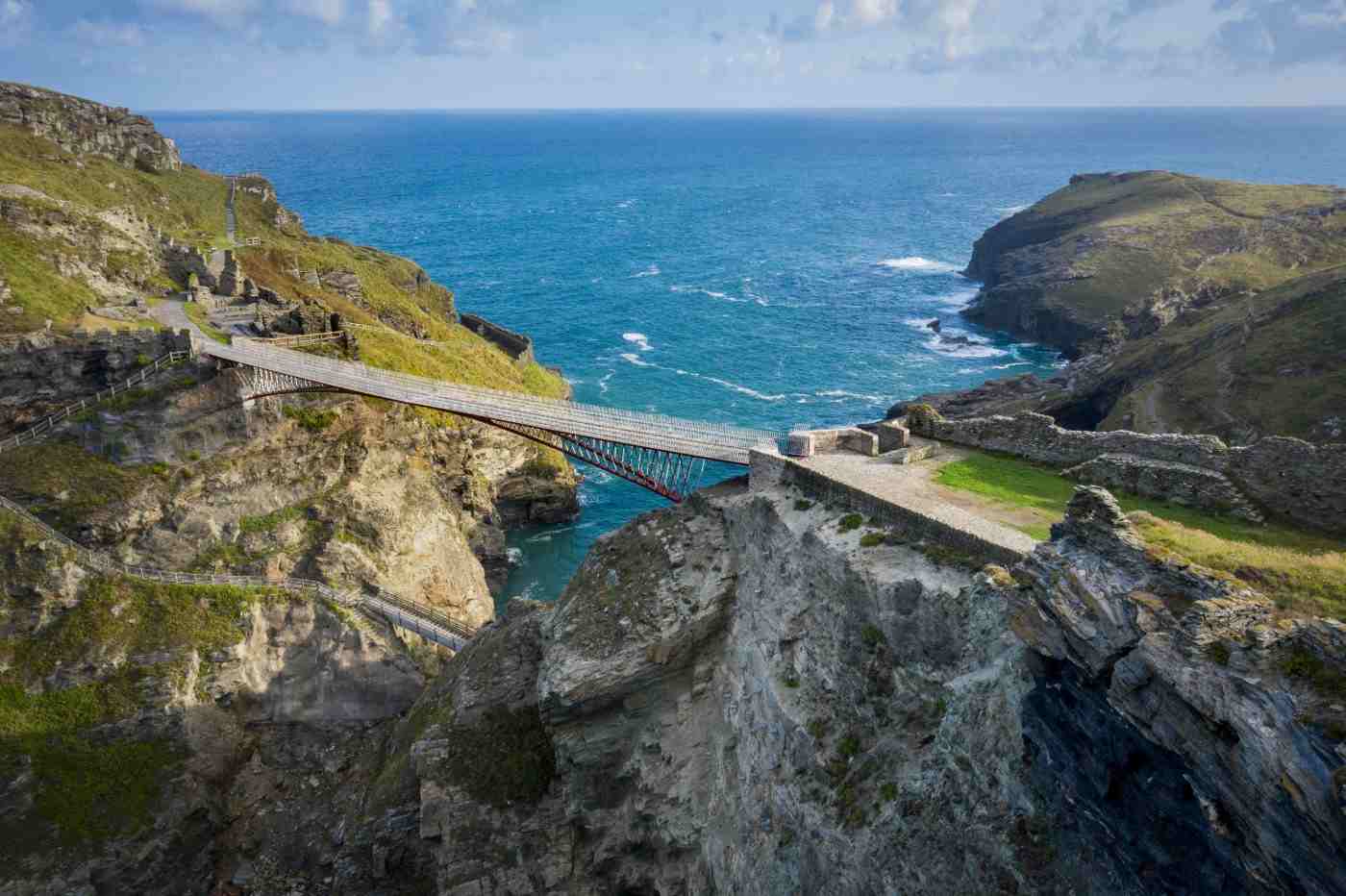 architects build a hanging bridge between ruins and cliffs