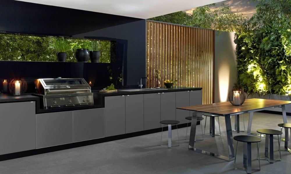 outdoor kitchen in dark colored shades of gray and black with plants