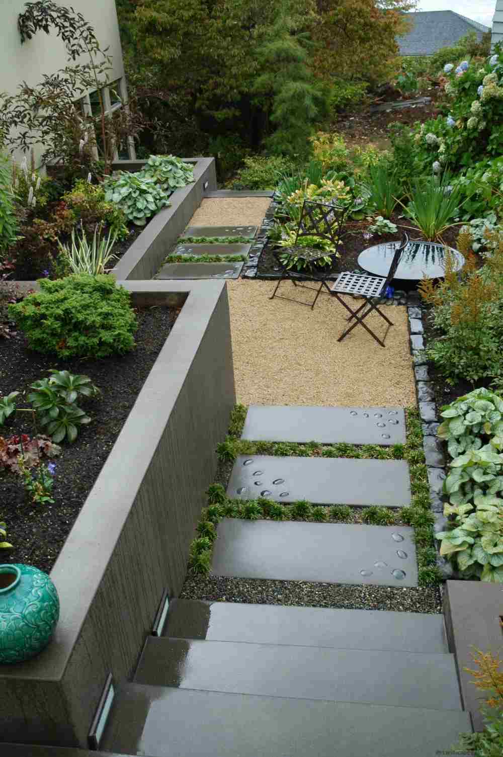 designer garden scraps with concrete stairs and garden plants and garden furniture garden