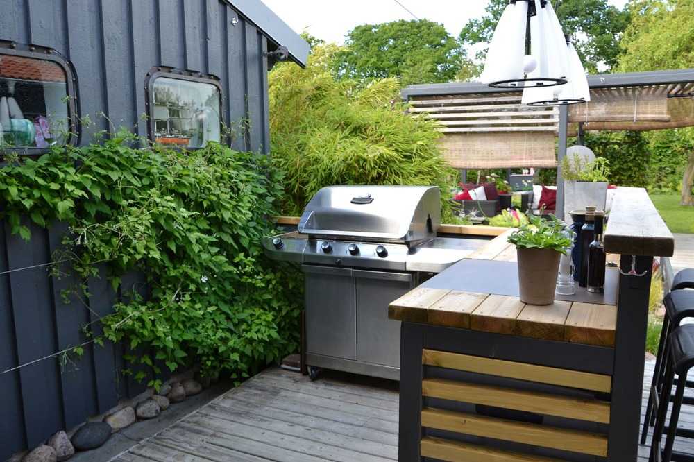a rustic gas grill outside kitchen in the backyard looks rustic