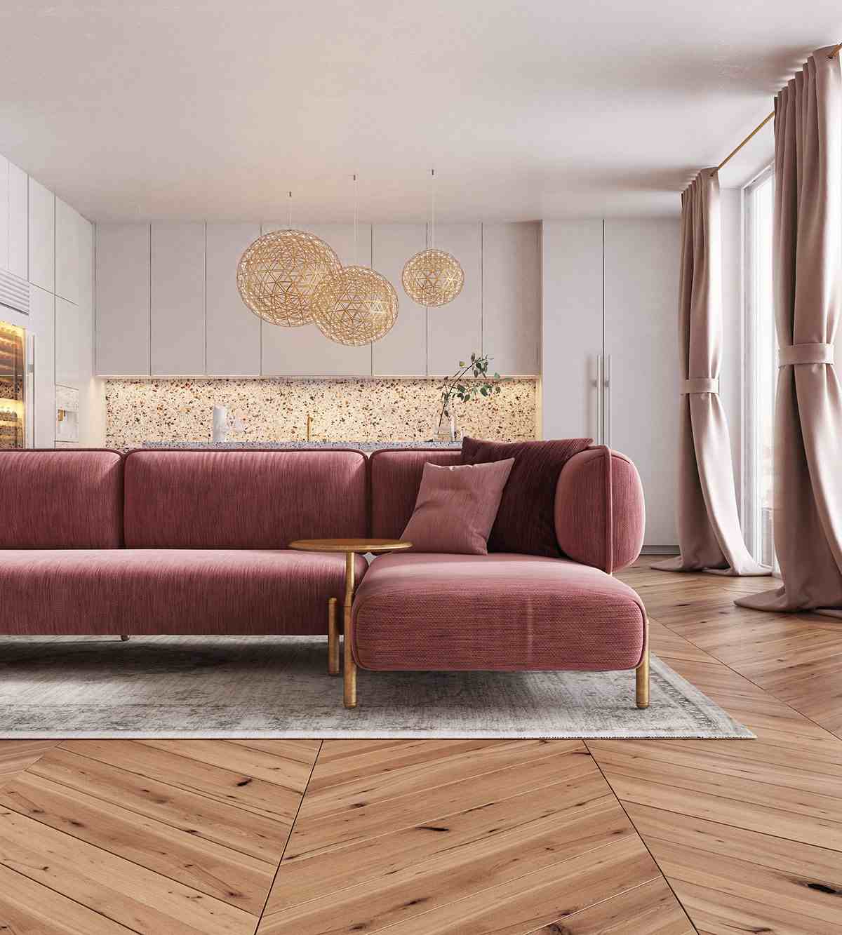 rosafarbene couch im 70er jahre stil kombiniert sich mit moderner küche und küchenrückewand aus terrazzoo material