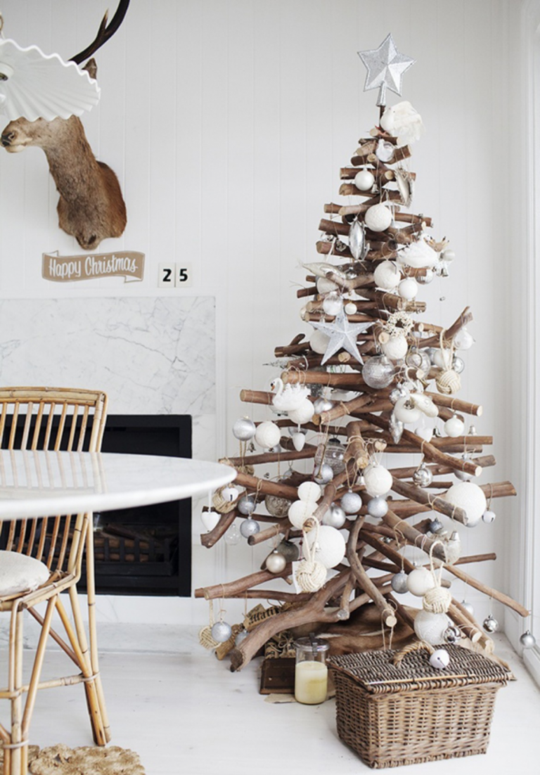 weihnachtsbaum aus holz basteln mit gestapelten baumzweigen und weißer weihnachtsdeko im rustikalen stil