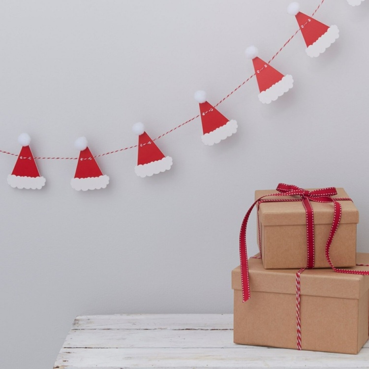 Girlande basteln für die Weihnachtsdeko mit einer Vorlage für Nikolausmützen aus Buntpapier