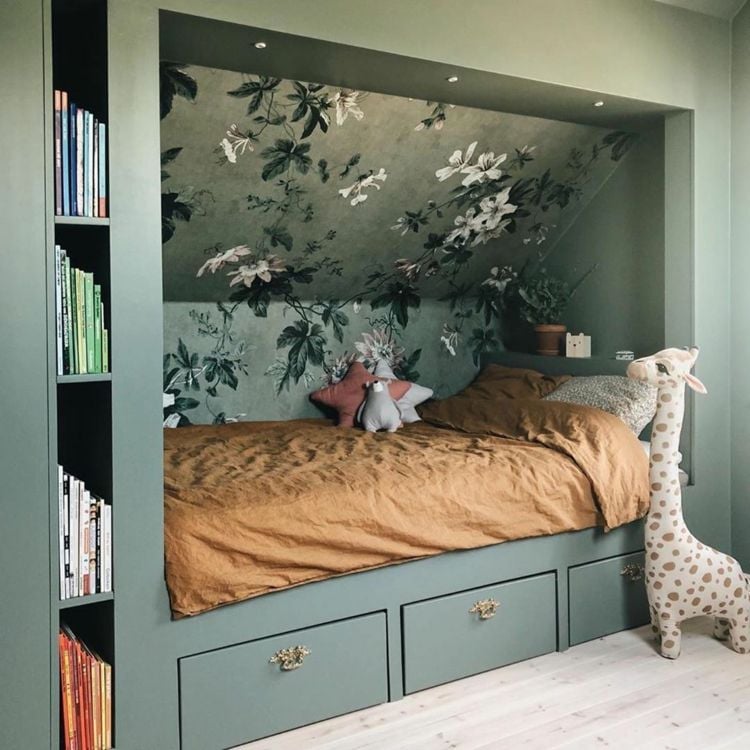Built-in bed under sloping ceilings decorated with wallpaper for girls