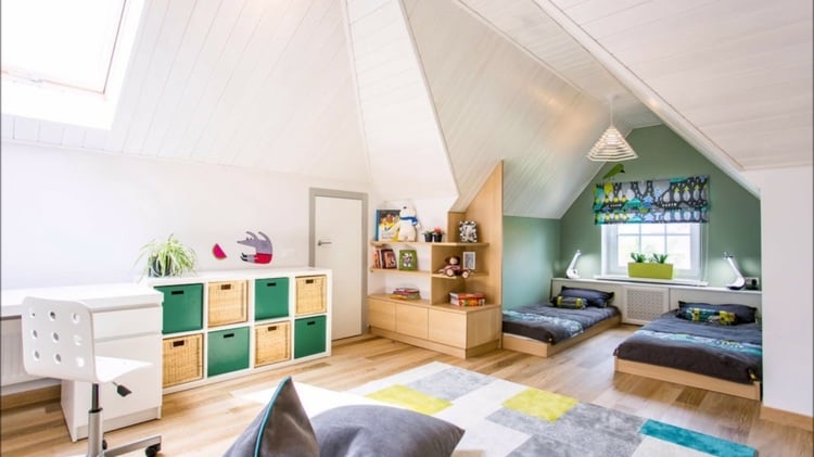 Large attic room with sleeping area with two beds and modern accessories