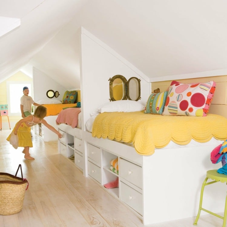 Nicely furnished attic room for children with built-in beds and partitions