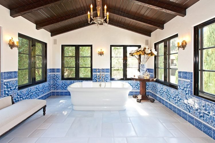 Bathroom with high ceiling and windows and free-standing bathtub