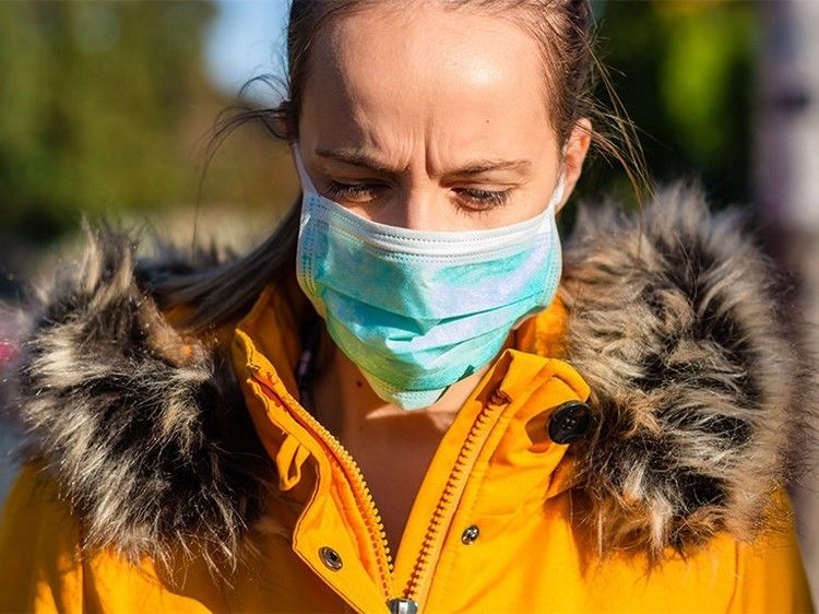 Woman wearing respirator in public