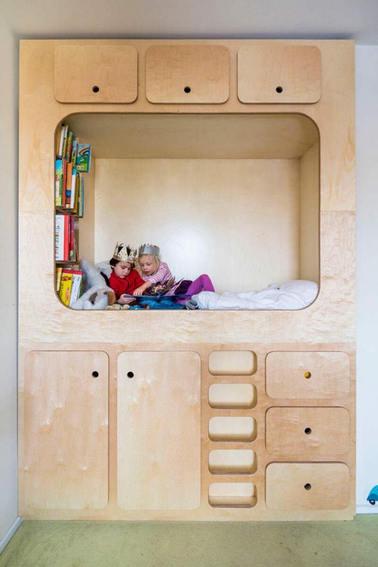 Cozy bed for children with modern wood paneling and built-in bookcase