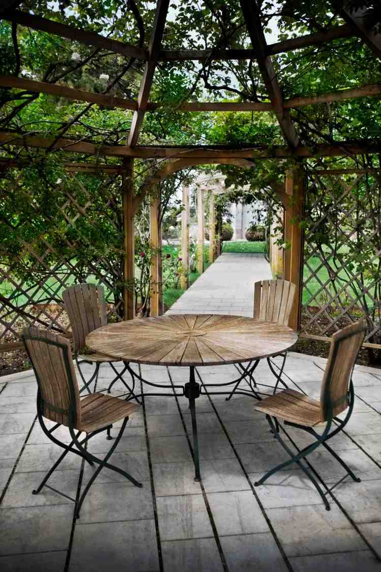gemütlicher patio bereich mit rundem tisch und beschattung durch gitter