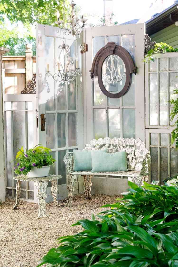 vintage design garden in white with old French doors and couch with iron coffee table