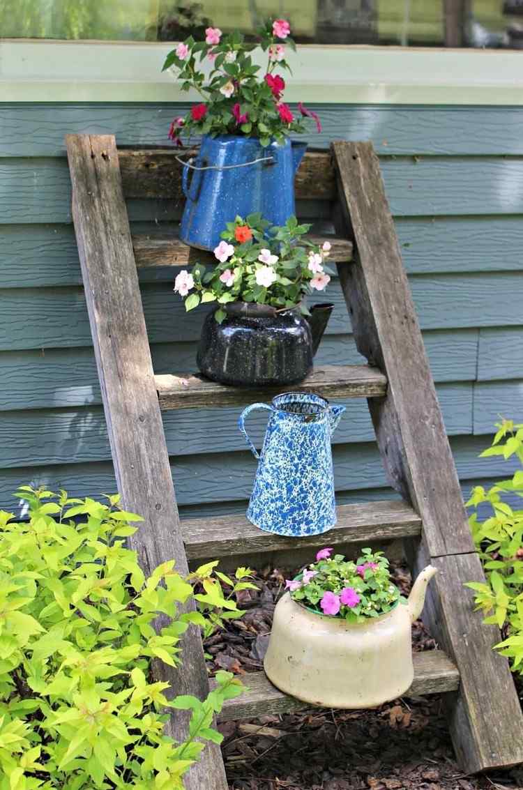 vintage garden decor ideas with old teapots on ladder
