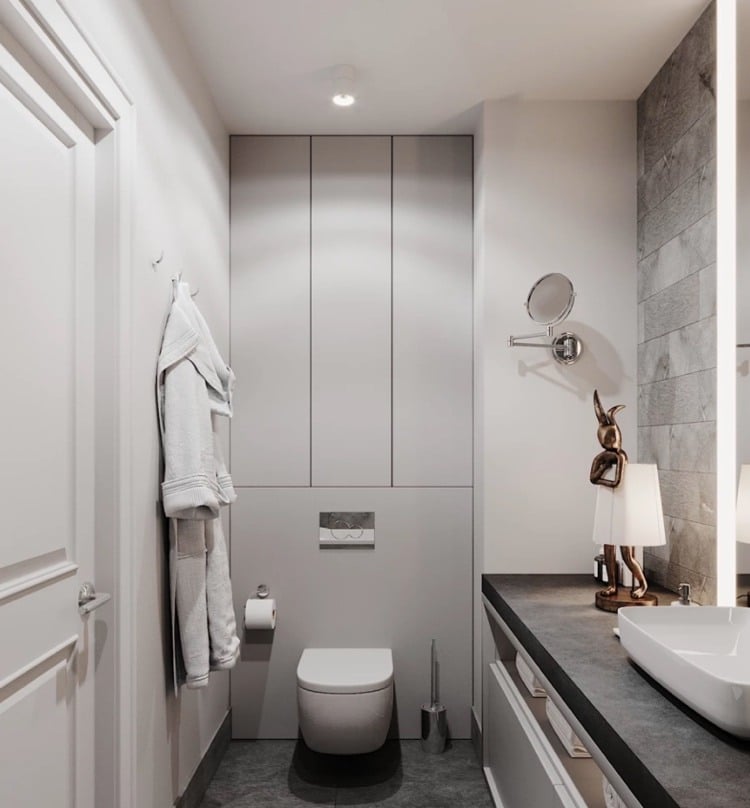 einbauschrank hinter wc in einem modernen grauen bad