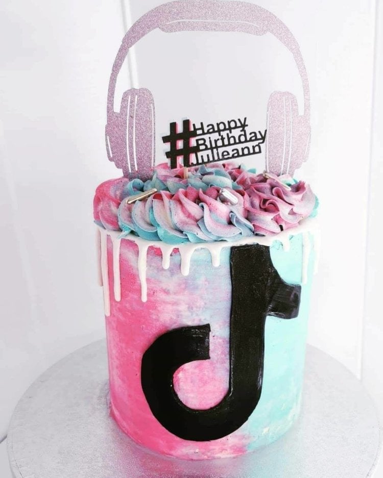 Feminine TikTok cake in pink and light blue with paper headphones as a cake decoration