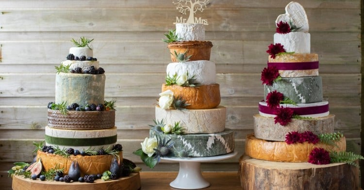 Big cake for the wedding made of cheese wheels - with fruits and flowers
