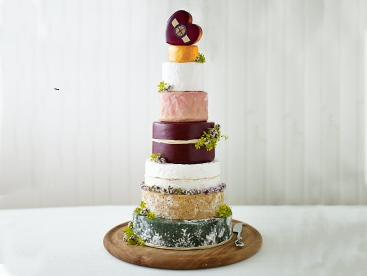 Cheese wedding cake with colored cheese rind and a heart shape on top