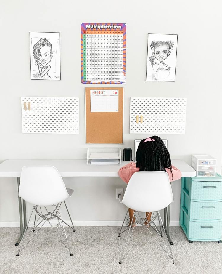 Small children's desk with modern Eames chairs and wall design