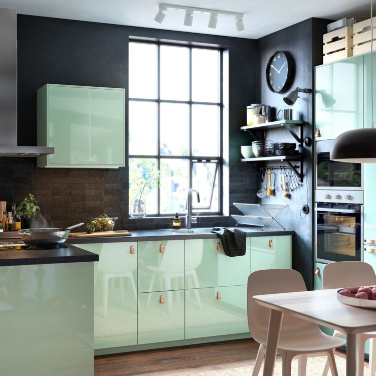Mint color kitchen in combination with black looks modern