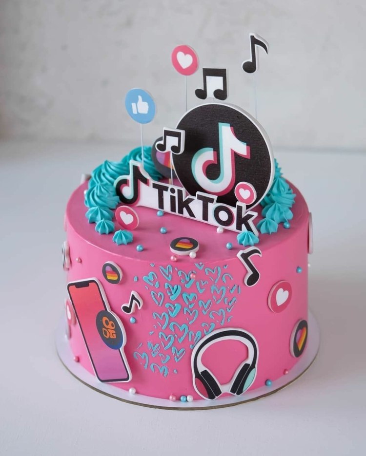 Pink TikTok cake with blue accents and mustical motifs