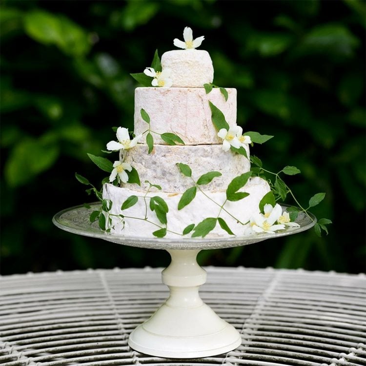White cheese wedding cake, simply decorated with jasmine