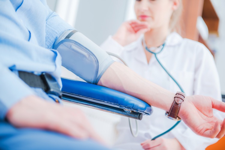 female doctor examines patient's blood pressure