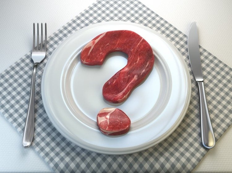 Raw meat forms a question mark in an empty plate