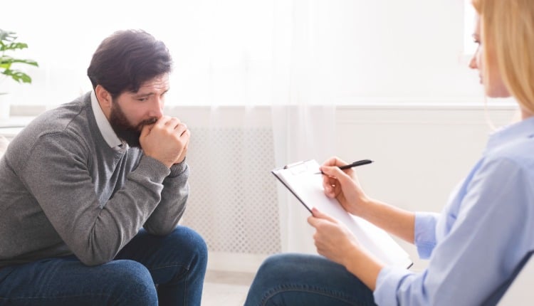 scared man with depression at psychologist