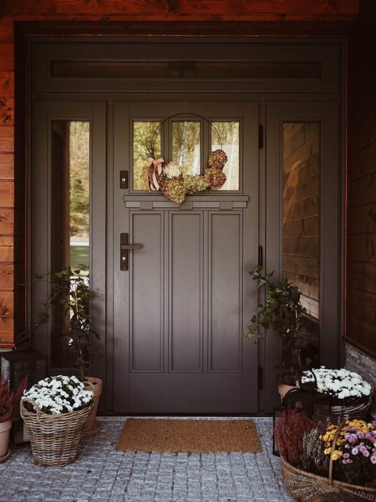 Decorate house entrance with white chrysanthemums and wreath with hydrangeas