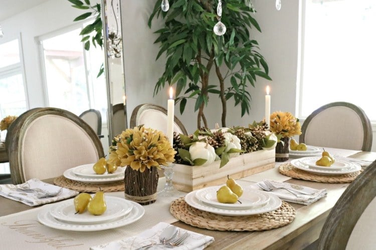Autumn decoration table with dried hydrangeas and pine cones and pears